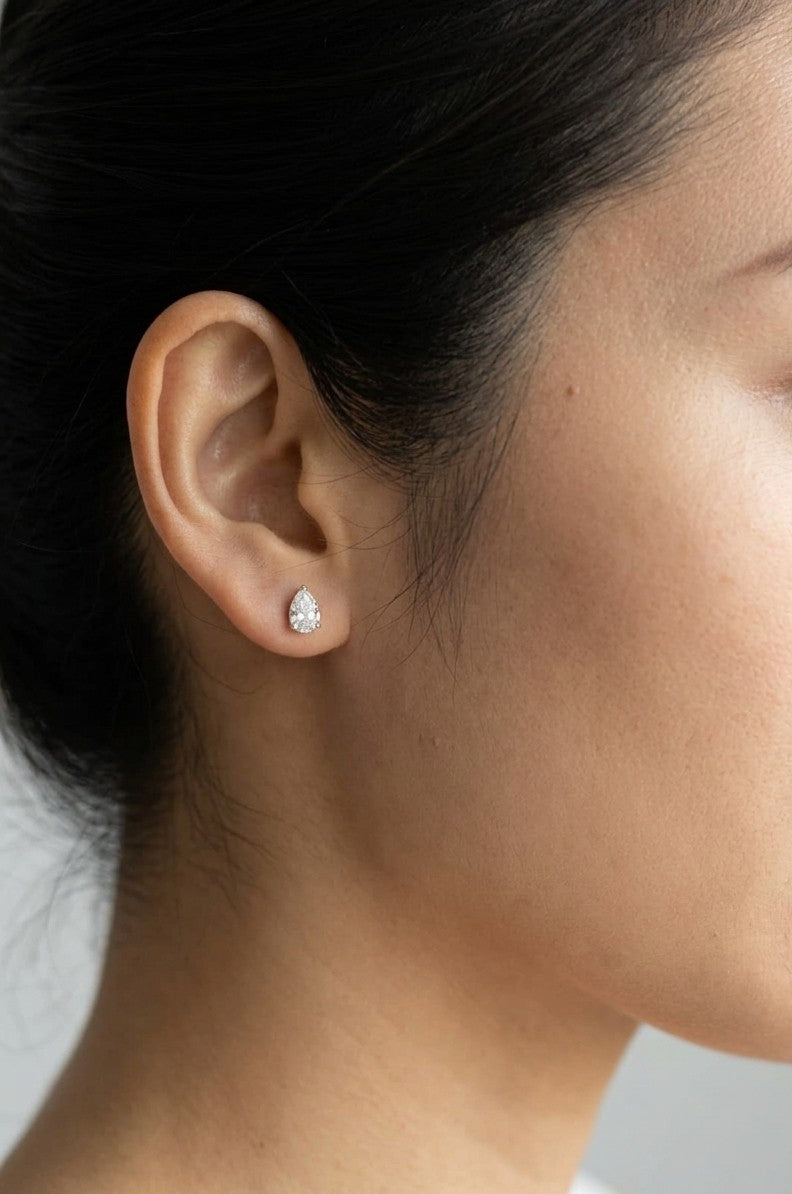 GIA certified pear shape diamond stud earrings in 18K white gold with two 0.50 carat D colour VS1 natural diamonds