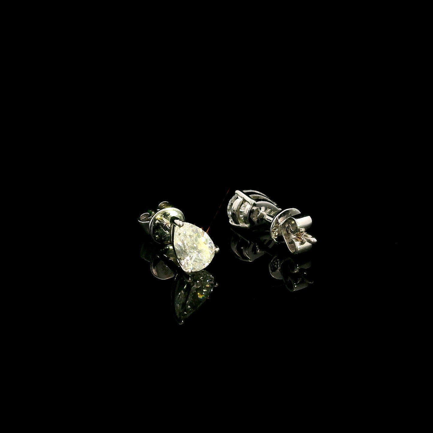GIA certified pear shape diamond stud earrings in 18K white gold with two 0.50 carat D colour VS1 natural diamonds