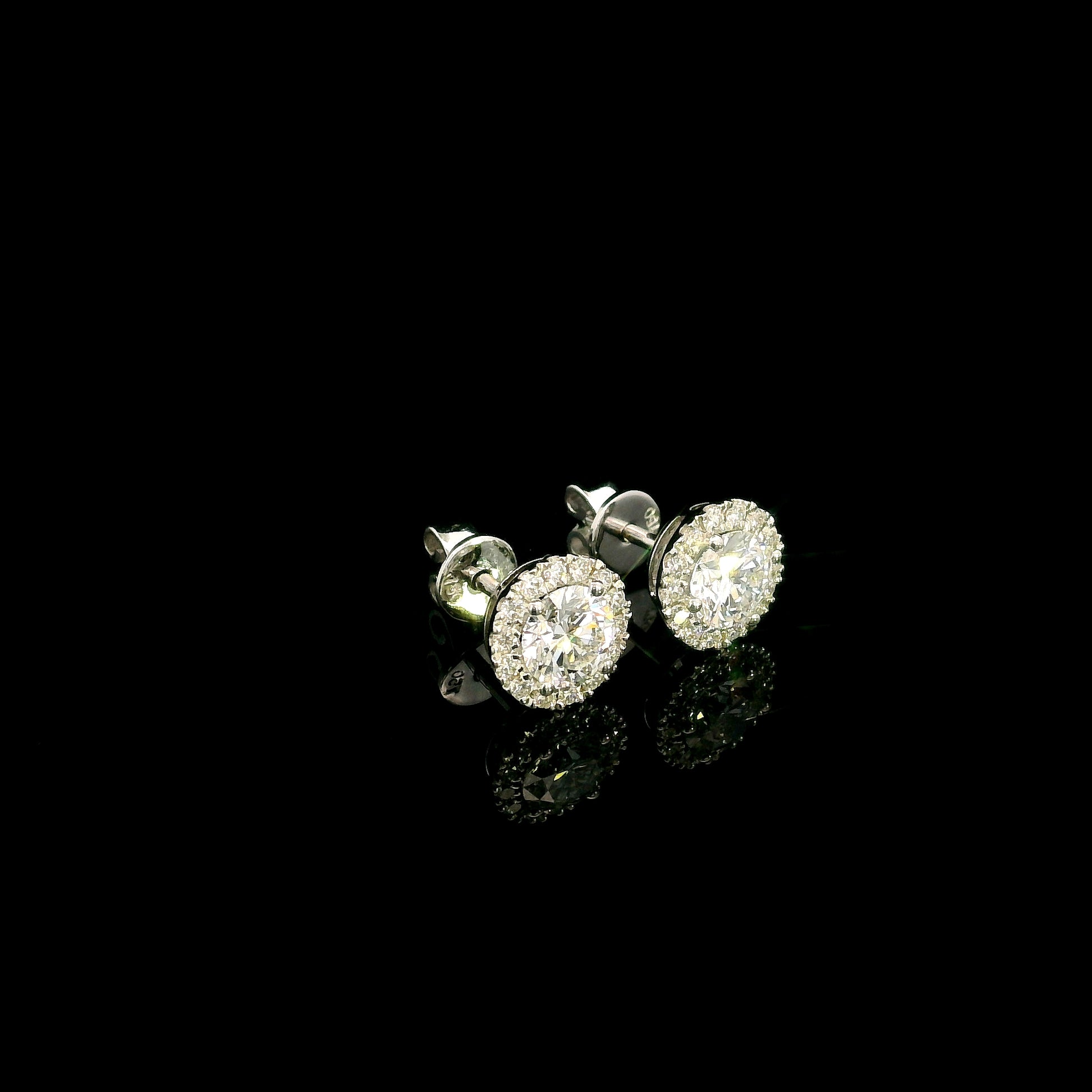 GIA certified round diamond halo stud earrings in 18K white gold with D colour natural centre diamonds