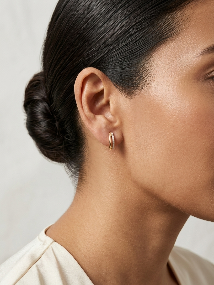 Small diamond huggie hoop earrings in 18K yellow gold by Emirates Diamonds