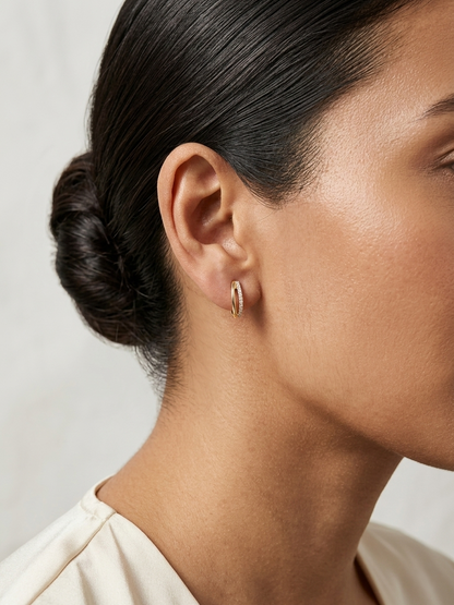 Small diamond huggie hoop earrings in 18K yellow gold by Emirates Diamonds