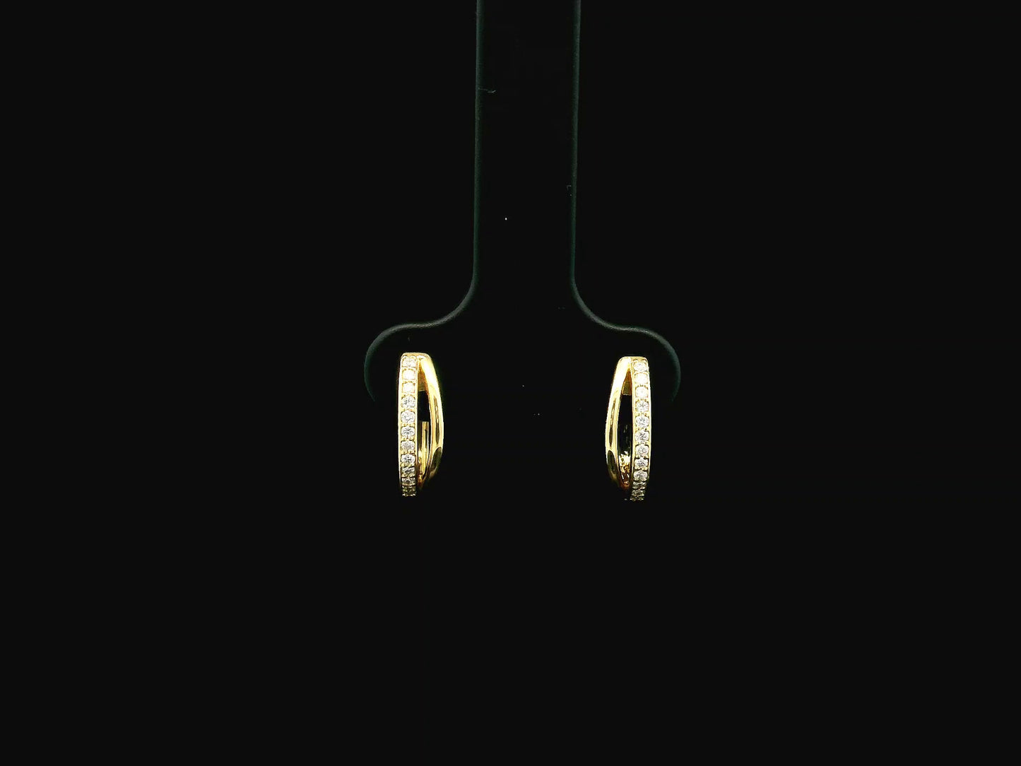 Small diamond huggie hoop earrings in 18K yellow gold by Emirates Diamonds