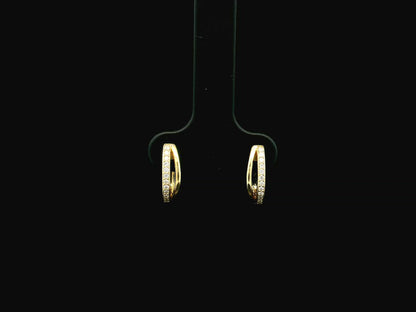 Small diamond huggie hoop earrings in 18K yellow gold by Emirates Diamonds