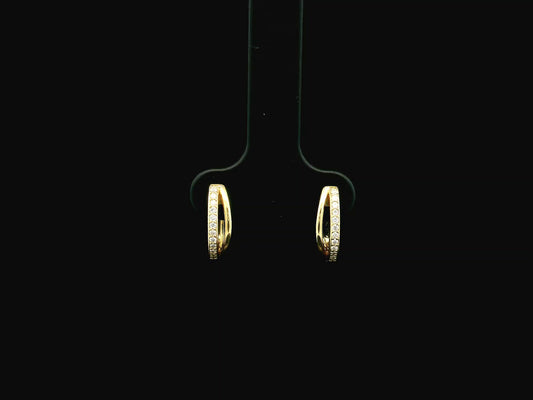 Small diamond huggie hoop earrings in 18K yellow gold by Emirates Diamonds