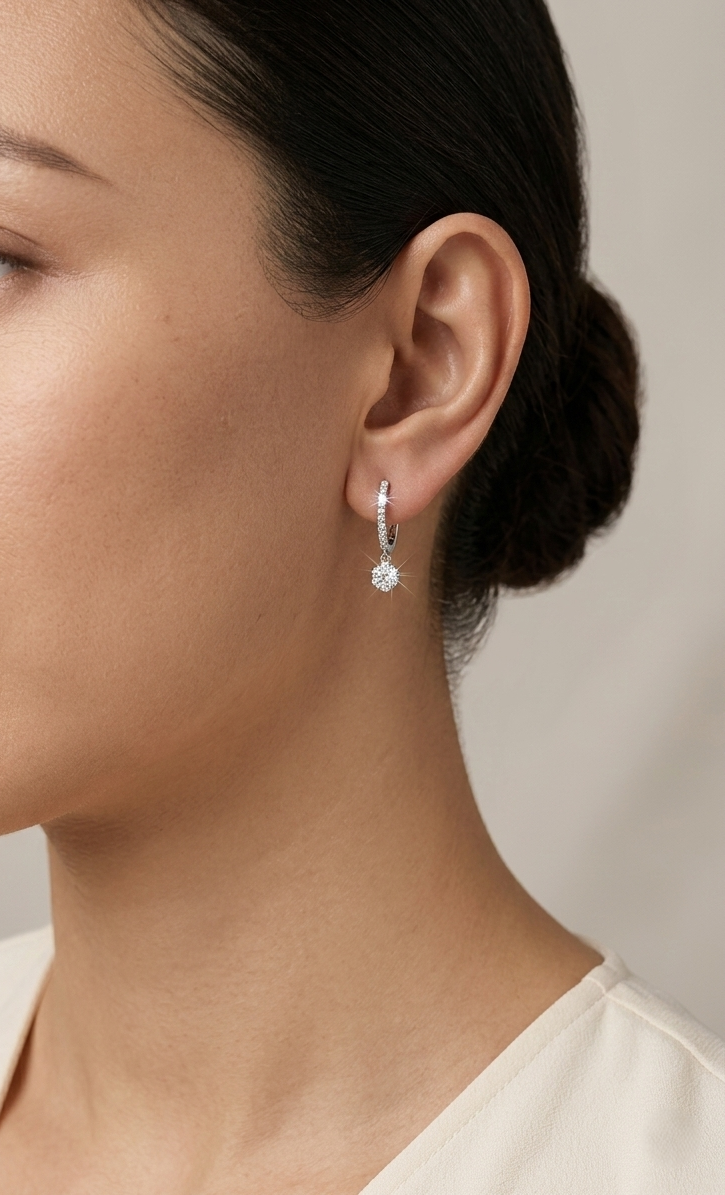 Diamond drop hoop earrings in 18K white gold featuring 0.59 carats of diamonds by Emirates Diamonds.