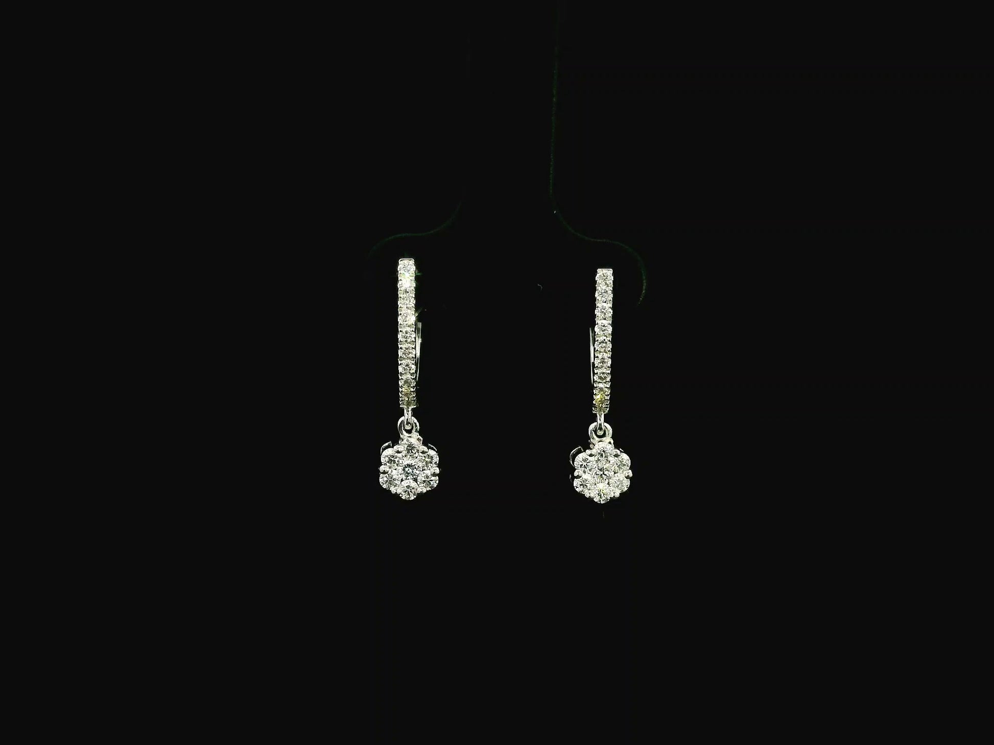 Diamond drop hoop earrings in 18K white gold featuring 0.59 carats of diamonds by Emirates Diamonds.