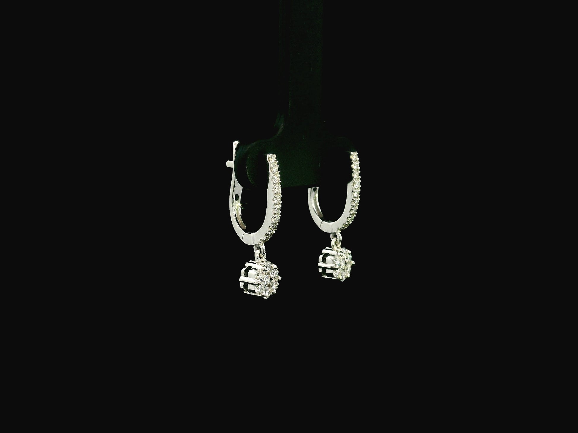 Diamond drop hoop earrings in 18K white gold featuring 0.59 carats of diamonds by Emirates Diamonds.