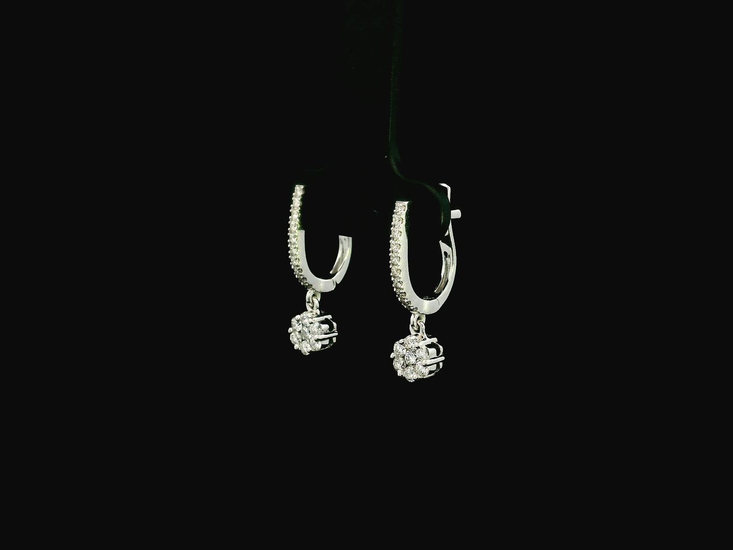 Diamond drop hoop earrings in 18K white gold featuring 0.59 carats of diamonds by Emirates Diamonds.