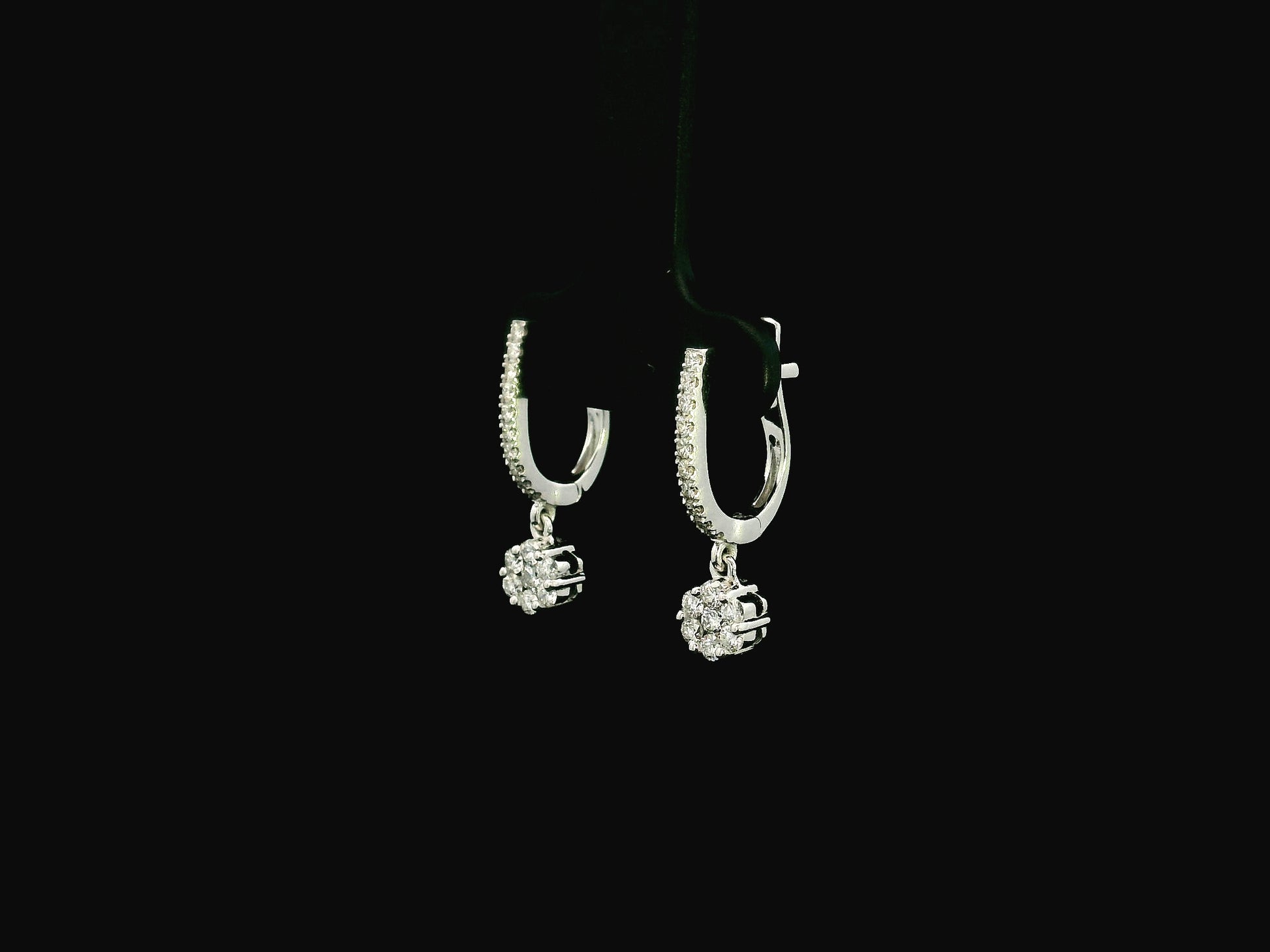 Diamond drop hoop earrings in 18K white gold featuring 0.59 carats of diamonds by Emirates Diamonds.
