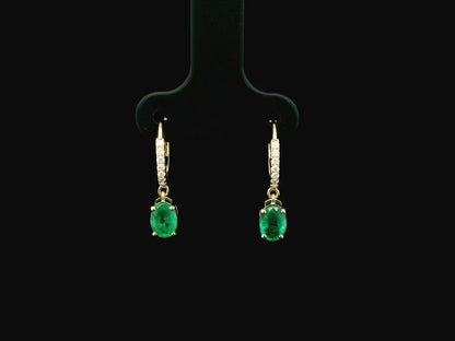 Emerald drop hoop earrings in 18K yellow gold with 0.95 carat emeralds and 0.09 carat diamond pavé hoops by Emirates Diamonds.