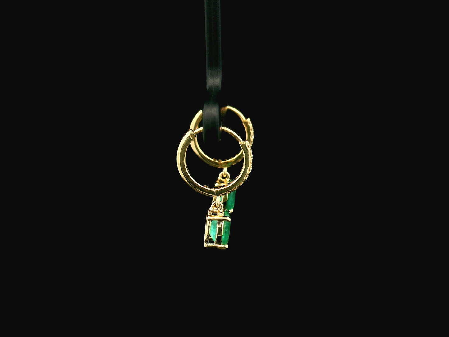 Emerald drop hoop earrings in 18K yellow gold with 0.95 carat emeralds and 0.09 carat diamond pavé hoops by Emirates Diamonds.