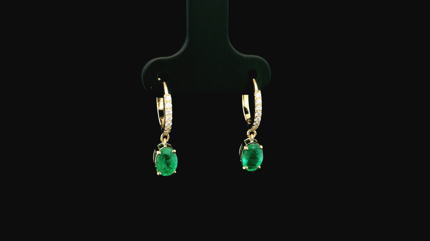 Emerald drop hoop earrings in 18K yellow gold with 0.95 carat emeralds and 0.09 carat diamond pavé hoops by Emirates Diamonds.