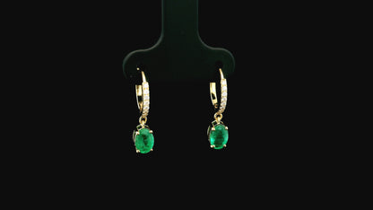 Emerald drop hoop earrings in 18K yellow gold with 0.95 carat emeralds and 0.09 carat diamond pavé hoops by Emirates Diamonds.