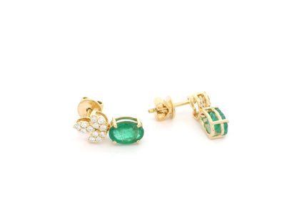 Emerald and diamond accent earrings in 18K yellow gold featuring 1.14 carat emeralds and 0.19 carat diamonds by Emirates Diamonds.