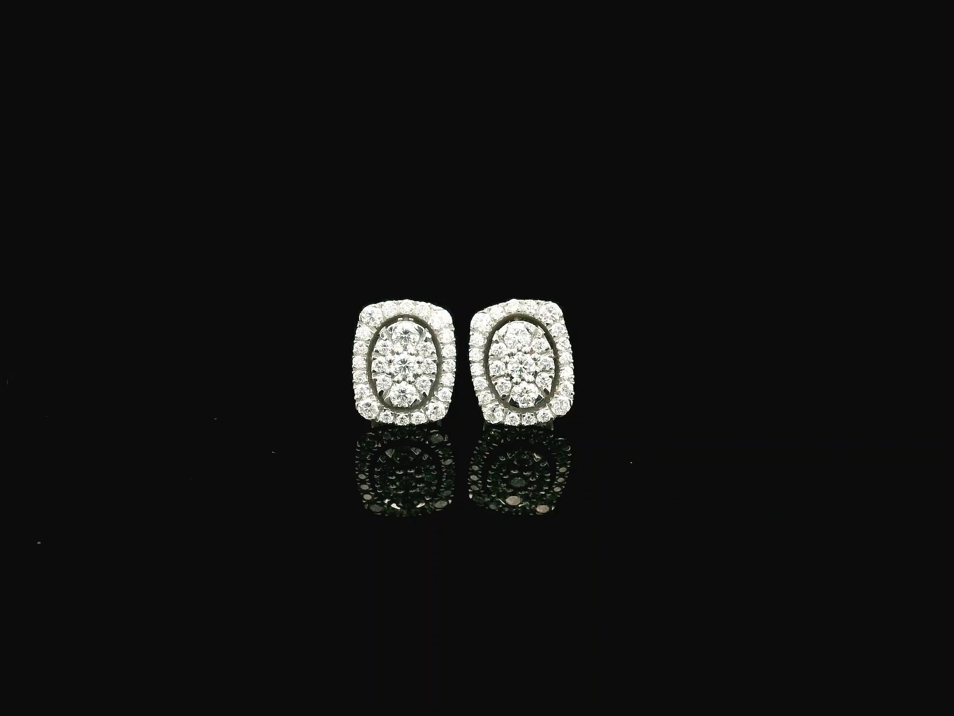 18K white gold diamond halo stud earrings featuring round brilliant diamonds with cushion halo design and 0.64 carat total diamond weight