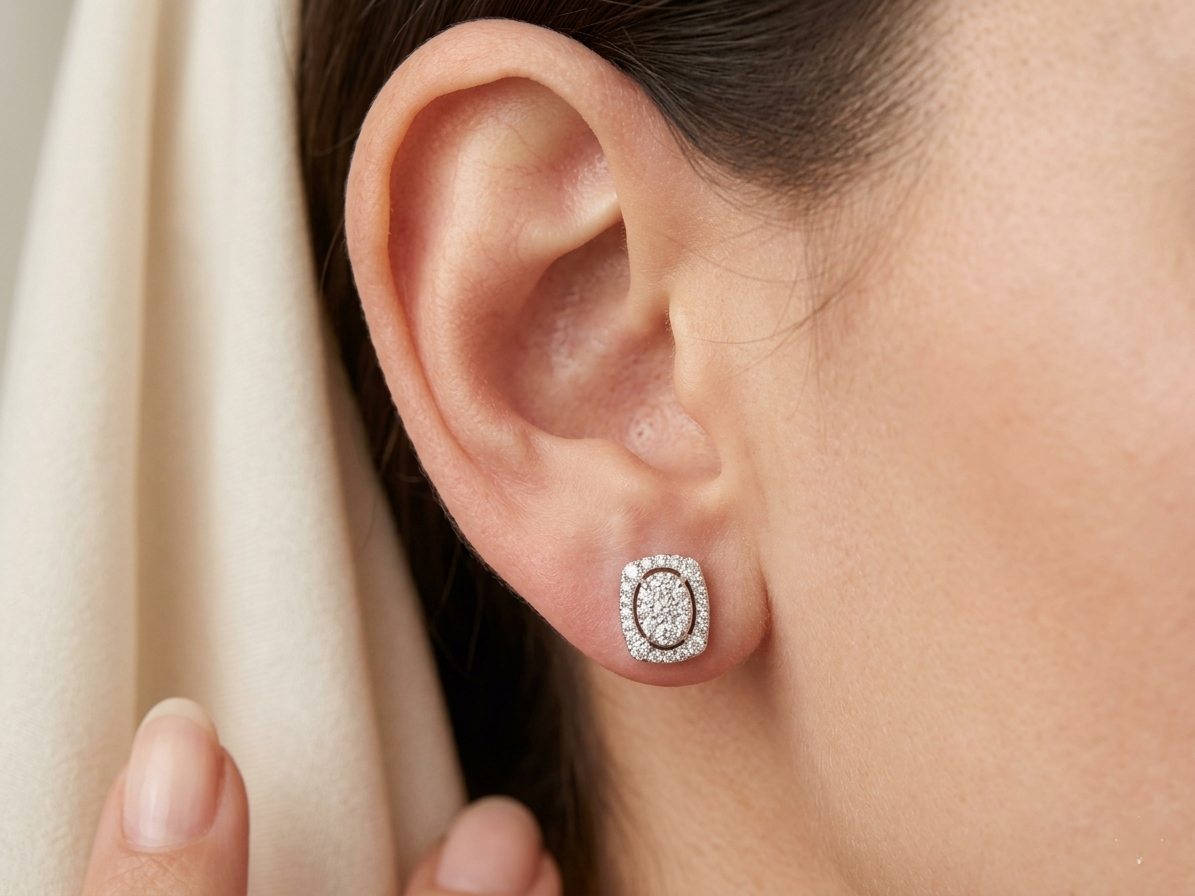 18K white gold diamond halo stud earrings featuring round brilliant diamonds with cushion halo design and 0.64 carat total diamond weight