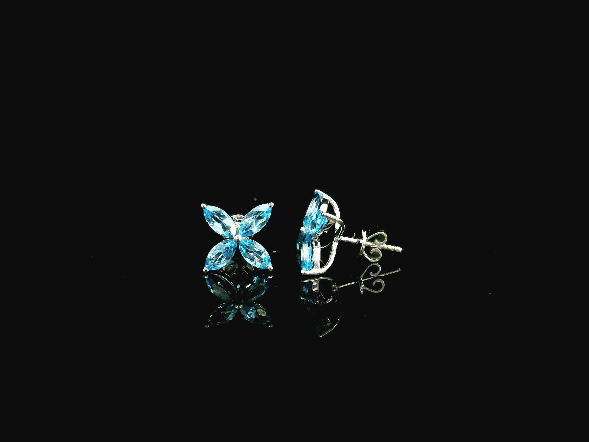 Blue topaz floral stud earrings in 18K white gold with marquise cut stones