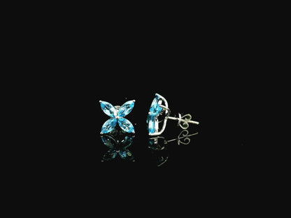 Blue topaz floral stud earrings in 18K white gold with marquise cut stones