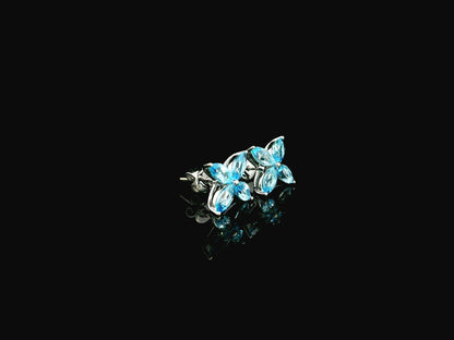 Blue topaz floral stud earrings in 18K white gold with marquise cut stones