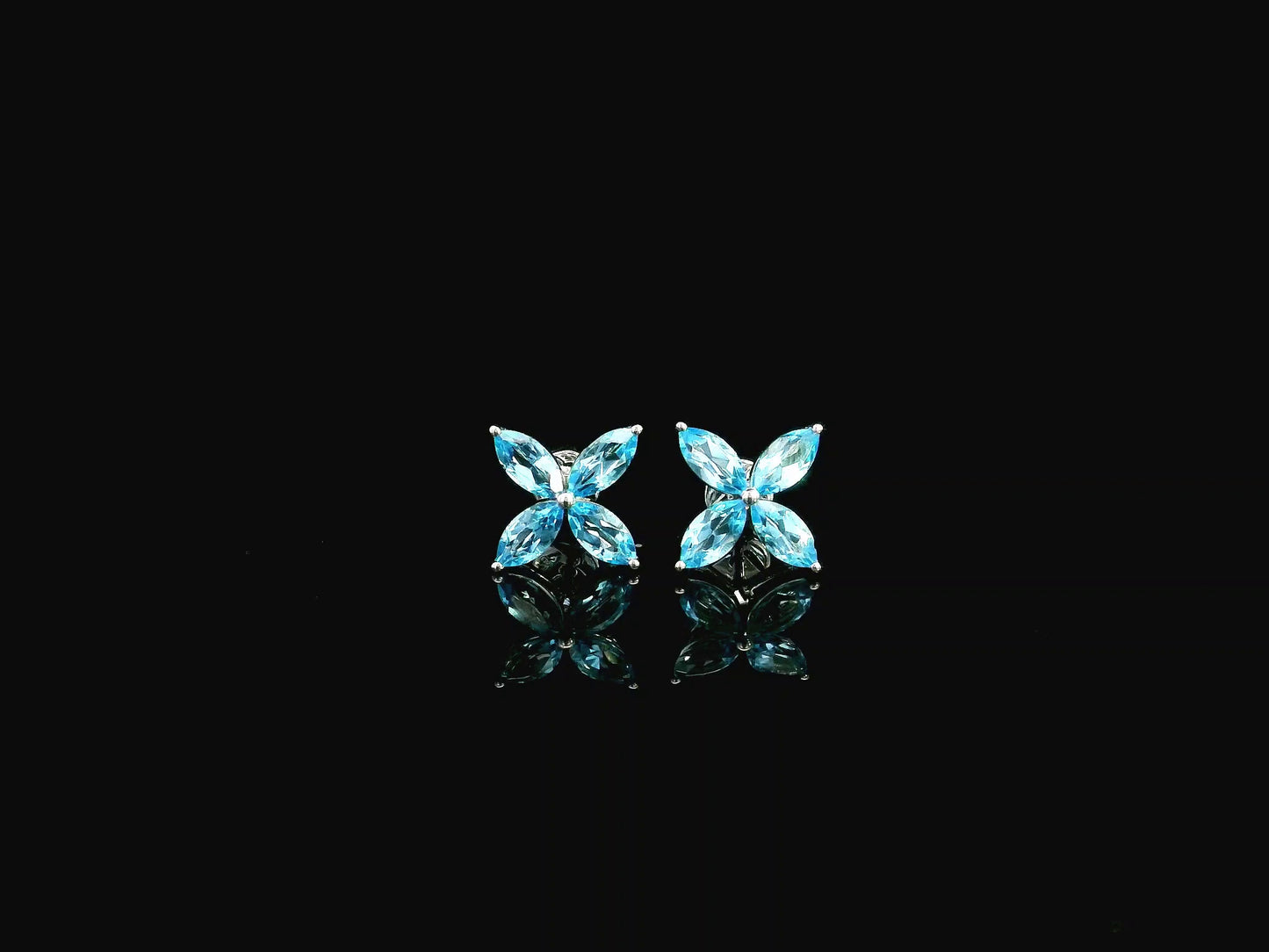 Blue topaz floral stud earrings in 18K white gold with marquise cut stones