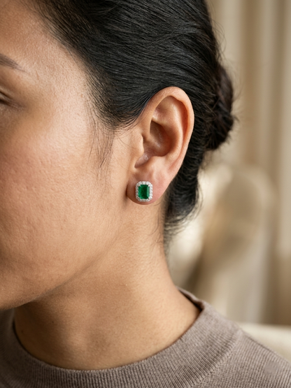 Emerald cut emerald and diamond halo stud earrings in 18K white gold Emirates Diamonds