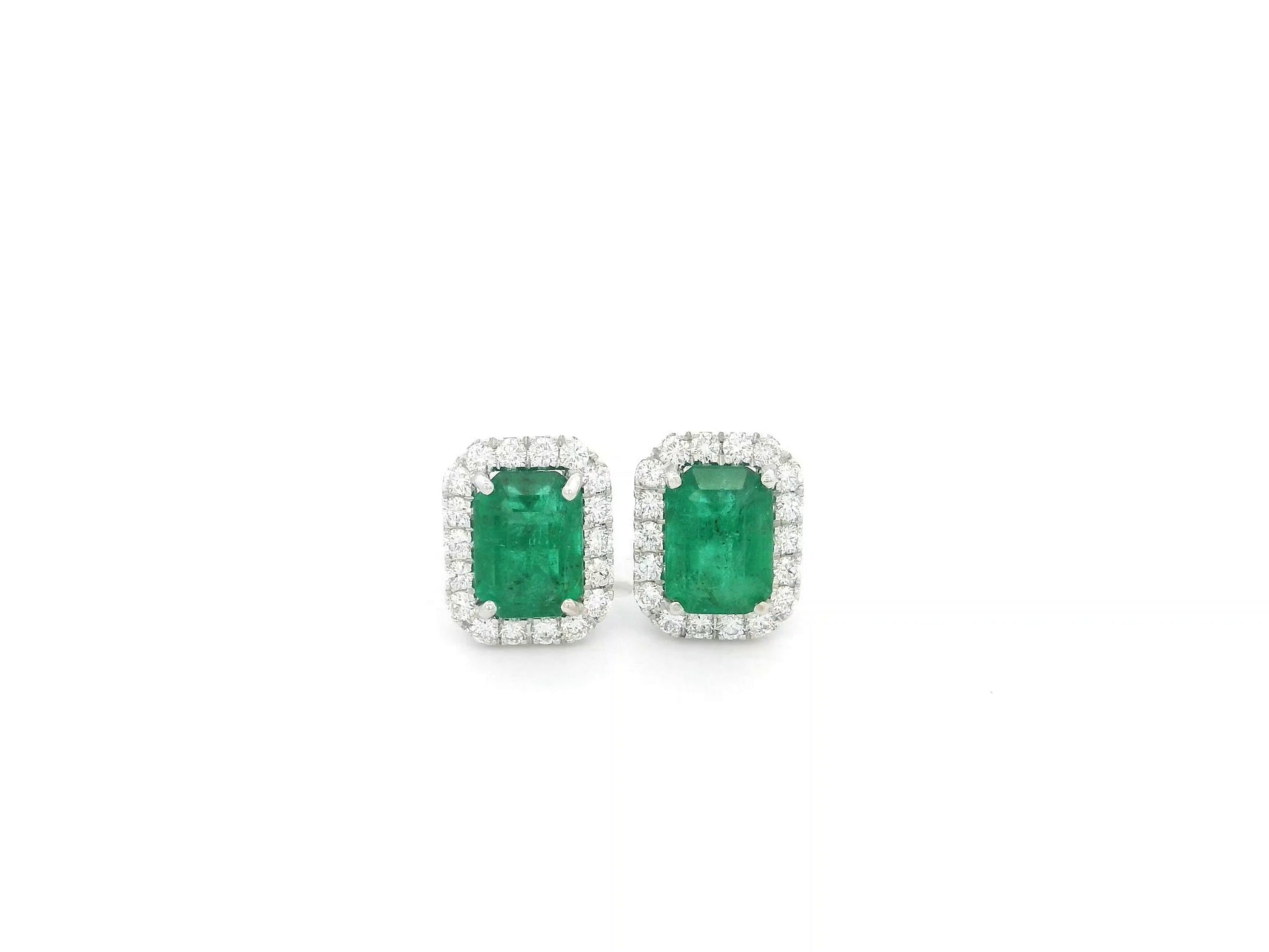 Emerald cut emerald and diamond halo stud earrings in 18K white gold Emirates Diamonds
