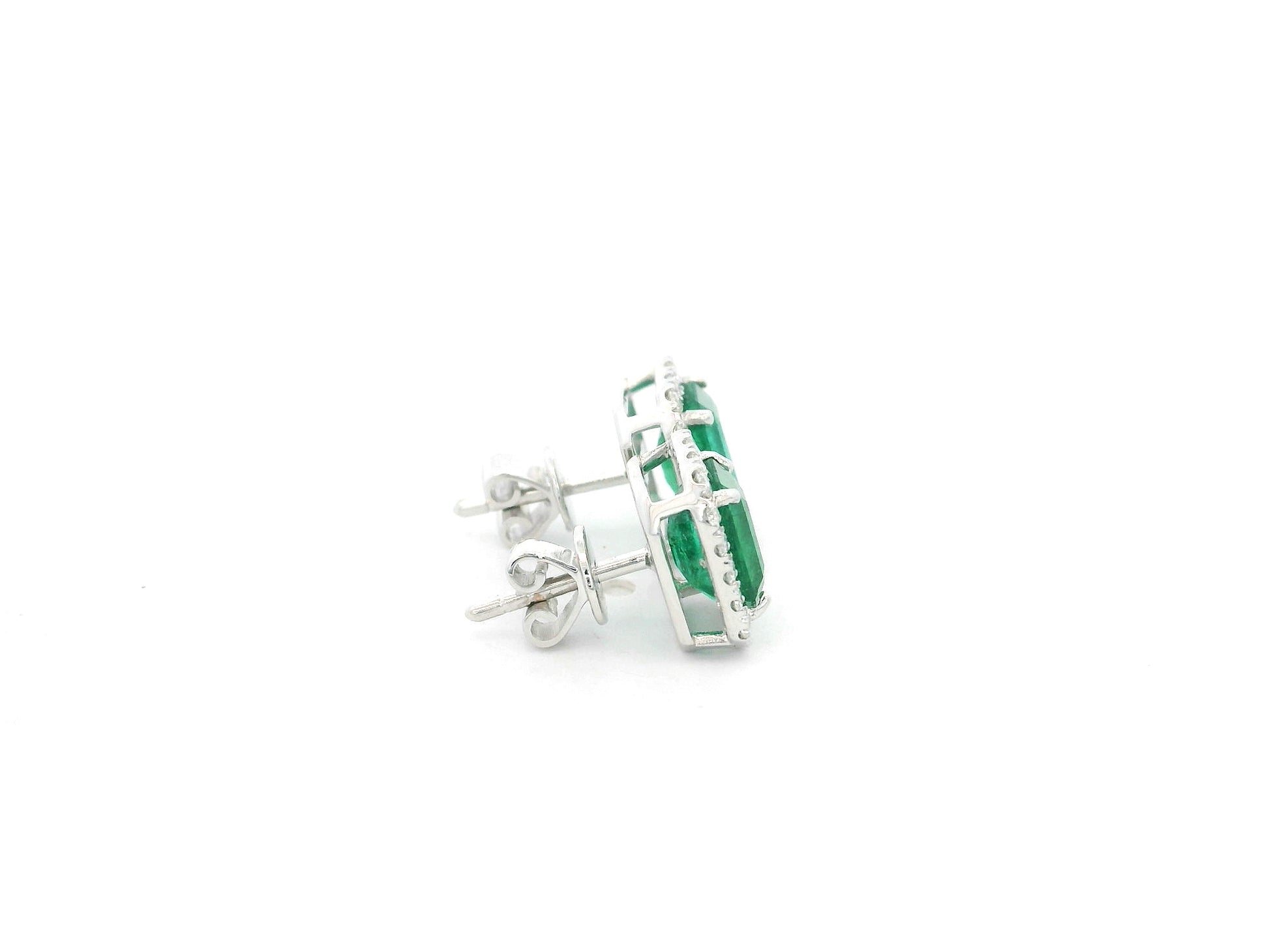 Emerald cut emerald and diamond halo stud earrings in 18K white gold Emirates Diamonds