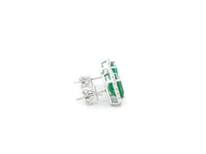 Emerald cut emerald and diamond halo stud earrings in 18K white gold Emirates Diamonds
