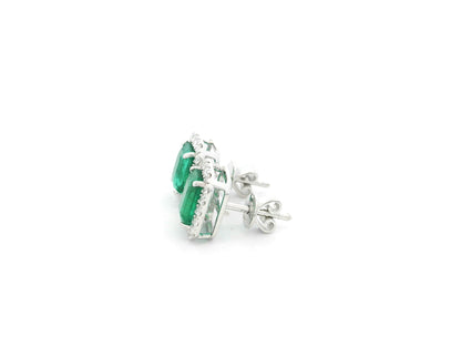 Emerald cut emerald and diamond halo stud earrings in 18K white gold Emirates Diamonds