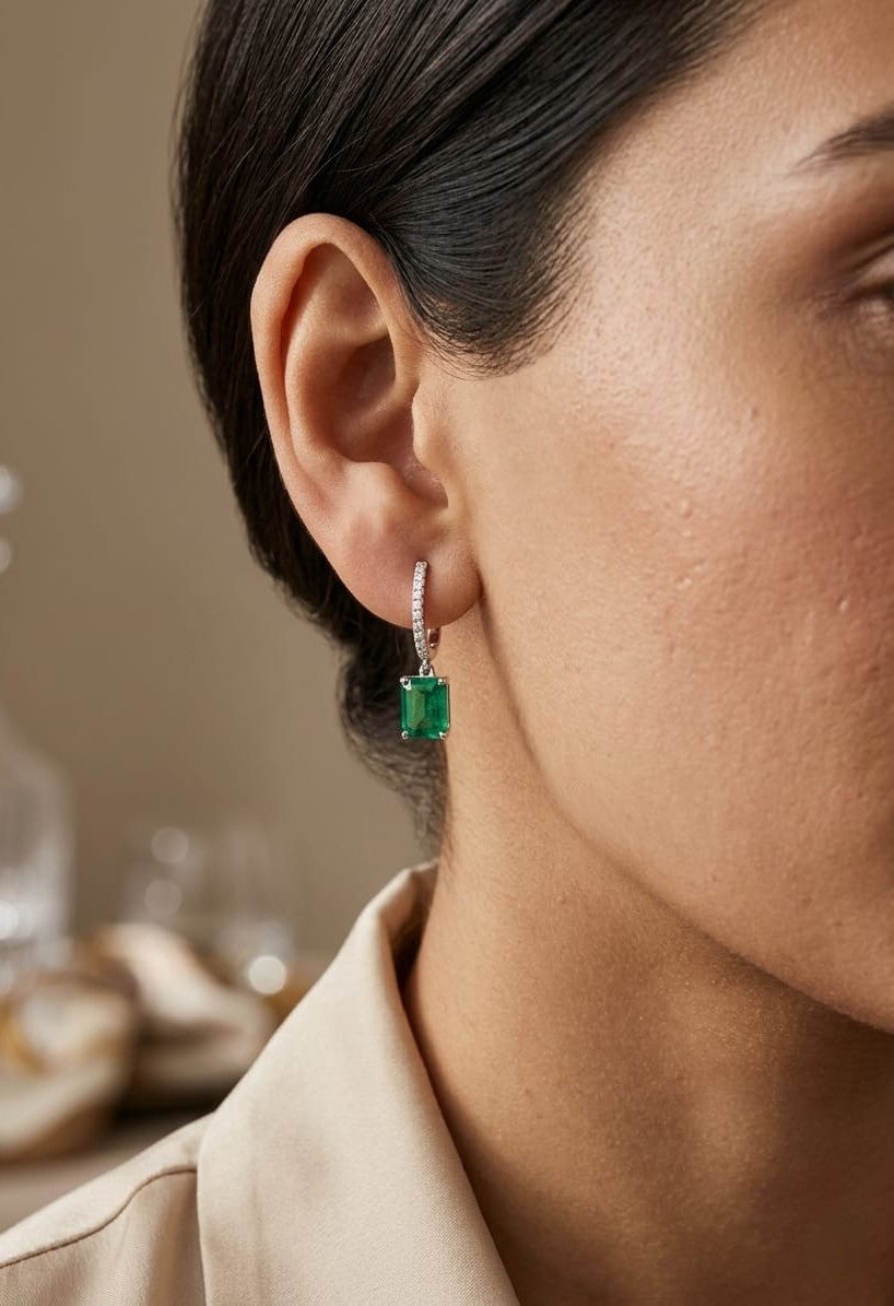 Emerald cut emerald drop earrings with diamond hoops in 18K white gold