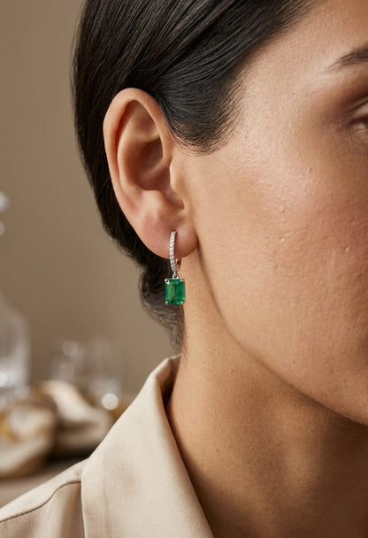 Emerald cut emerald drop earrings with diamond hoops in 18K white gold