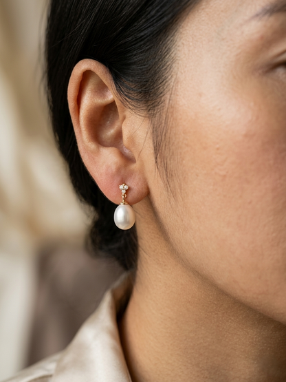 White pearl drop earrings with diamond accents in 18K yellow gold