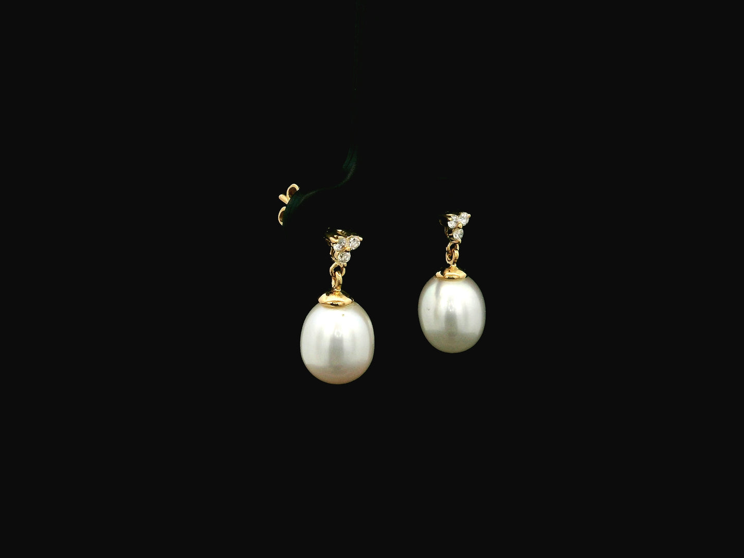 White pearl drop earrings with diamond accents in 18K yellow gold