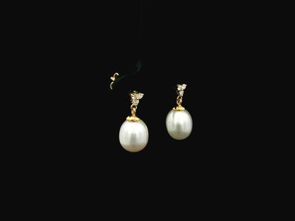 White pearl drop earrings with diamond accents in 18K yellow gold