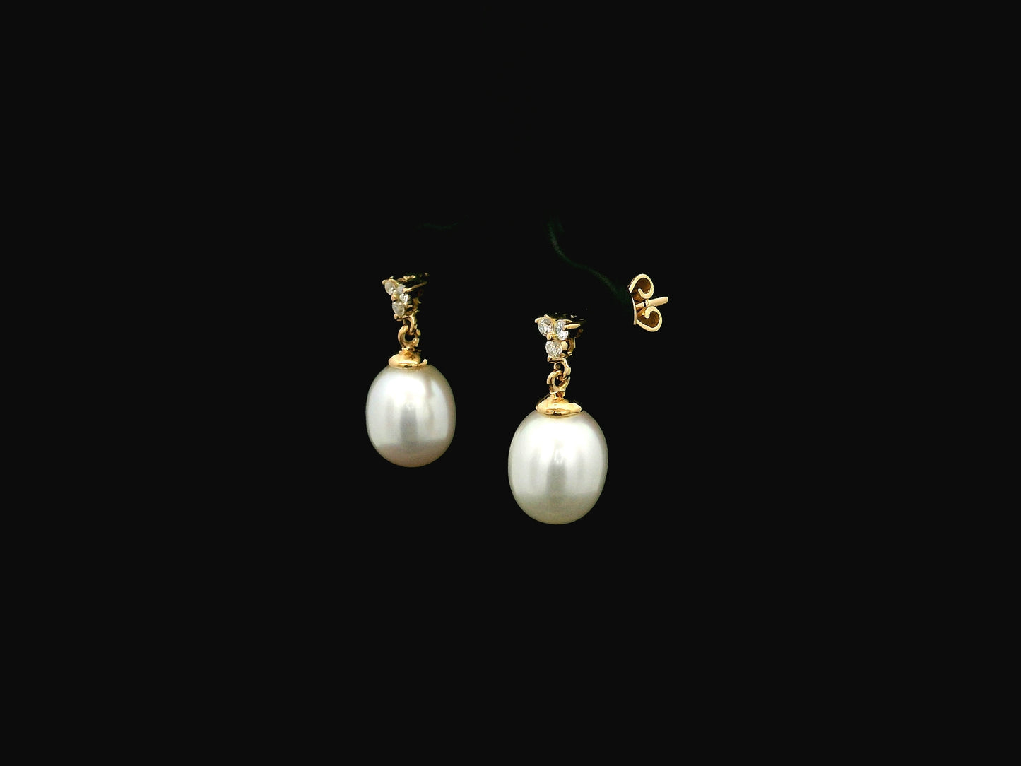 White pearl drop earrings with diamond accents in 18K yellow gold