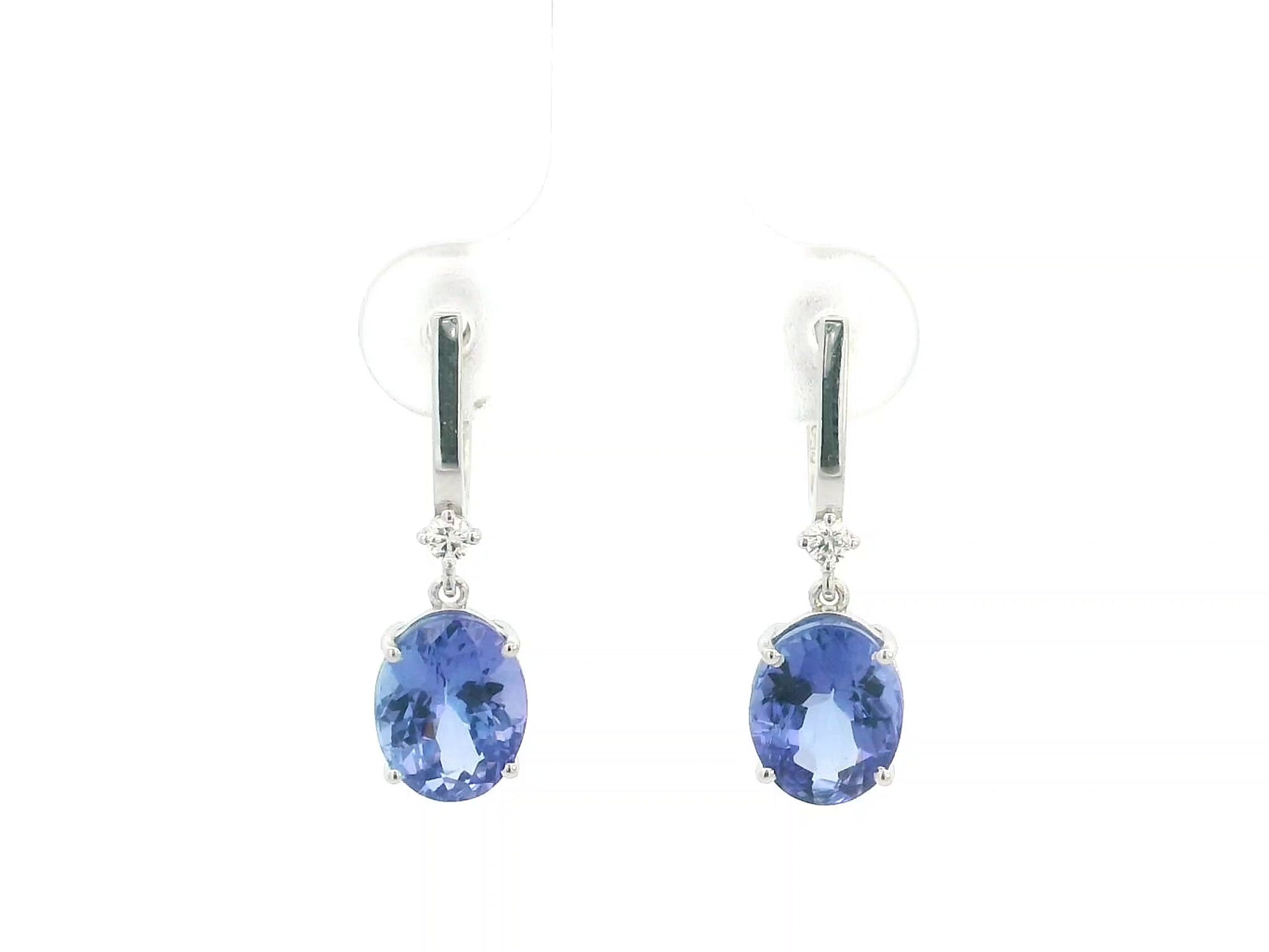 18K white gold tanzanite drop earrings with oval tanzanites and diamond accents