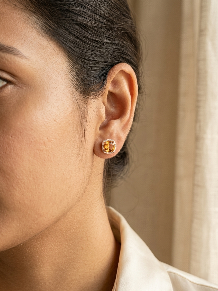 Citrine and diamond halo stud earrings in 18K yellow gold with cushion-cut citrine gemstones