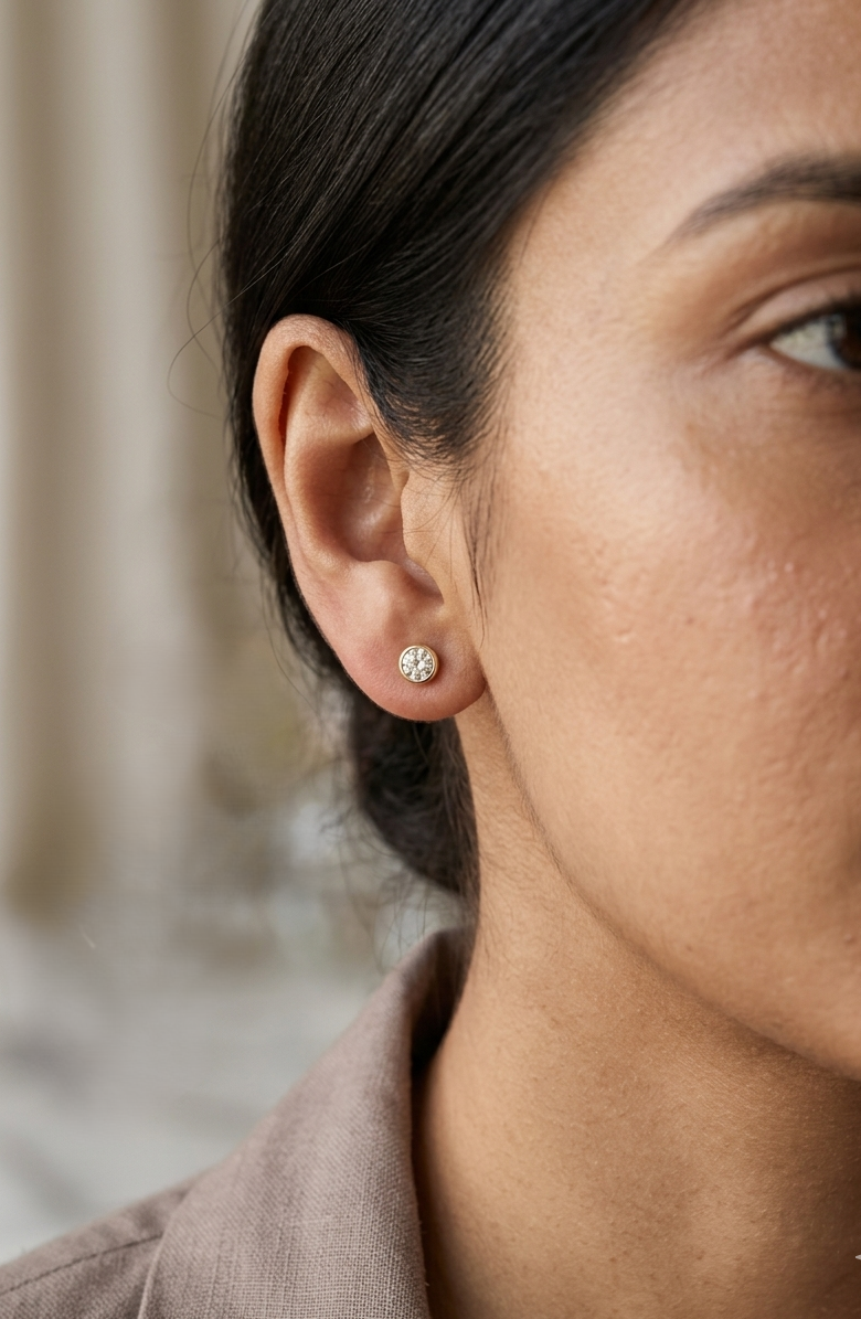 18K yellow gold bezel-set diamond stud earrings with round brilliant diamonds.