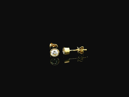 18K yellow gold bezel-set diamond stud earrings with round brilliant diamonds.