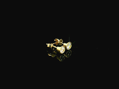 18K yellow gold bezel-set diamond stud earrings with round brilliant diamonds.
