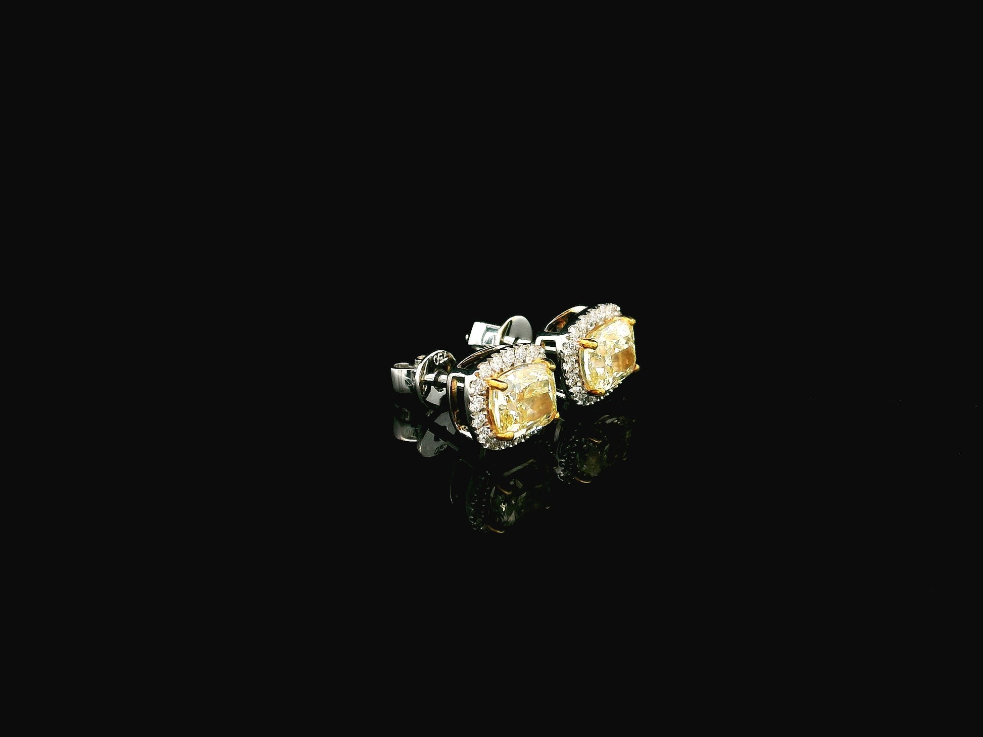 18K white gold fancy yellow cushion cut diamond halo stud earrings with GIA certified VS1 diamonds
