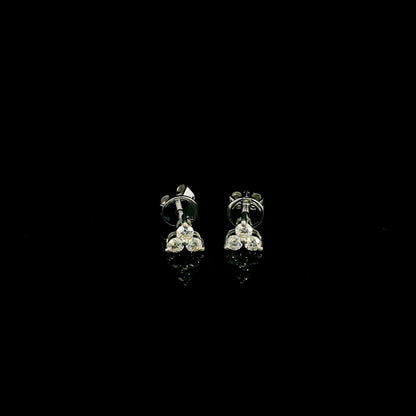 18K white gold diamond stud earrings featuring a delicate three-diamond design with a total diamond weight of 0.20 carat.