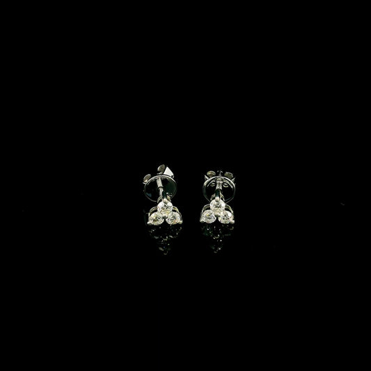 18K white gold diamond stud earrings featuring a delicate three-diamond design with a total diamond weight of 0.20 carat.