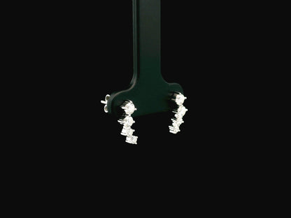 Graduated natural diamond drop earrings in 18K white gold, 0.55 carat total diamond weight.