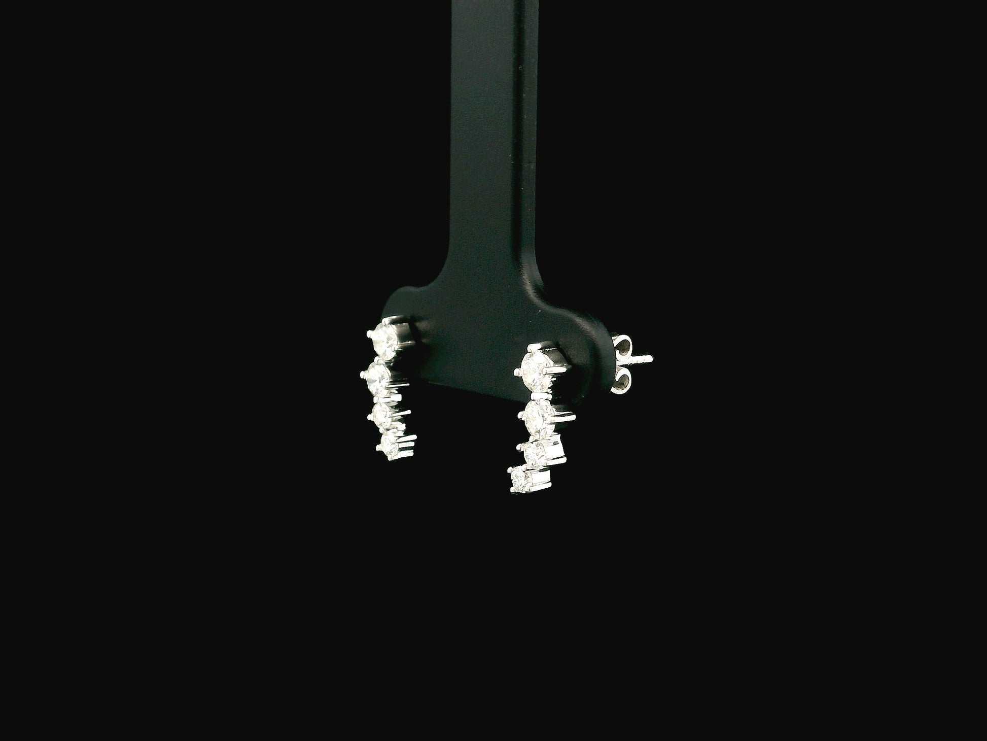 Graduated natural diamond drop earrings in 18K white gold, 0.55 carat total diamond weight.