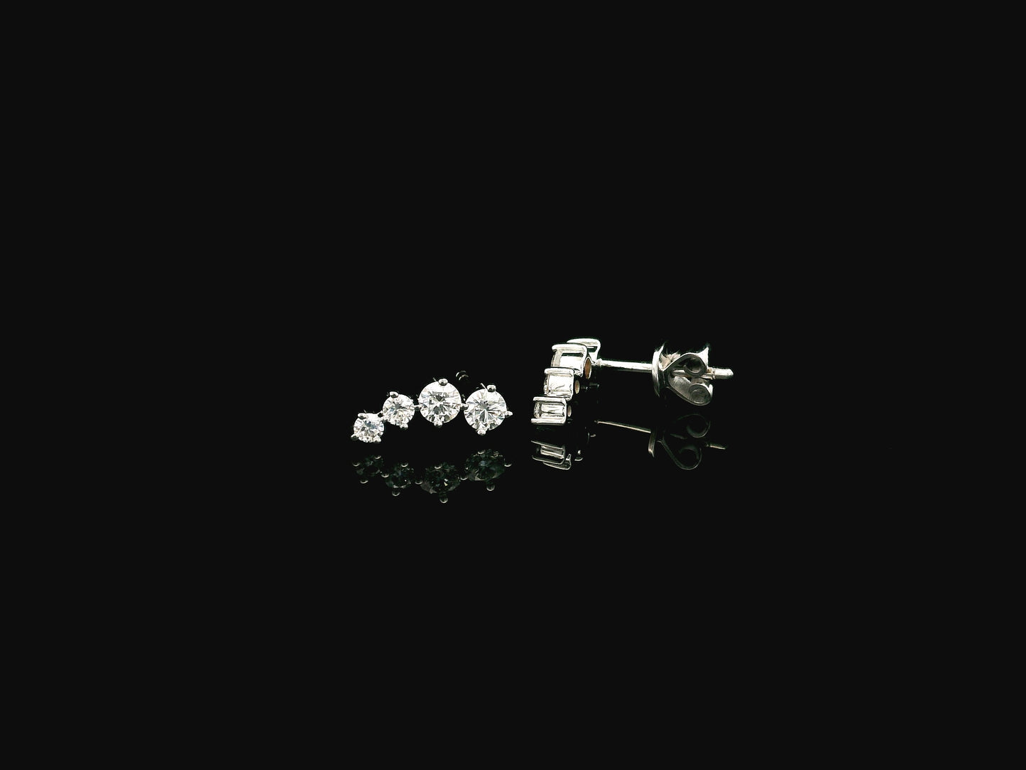 Graduated natural diamond drop earrings in 18K white gold, 0.55 carat total diamond weight.