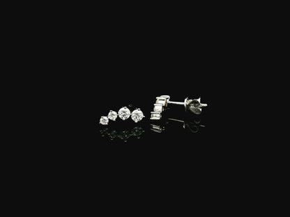 Graduated natural diamond drop earrings in 18K white gold, 0.55 carat total diamond weight.