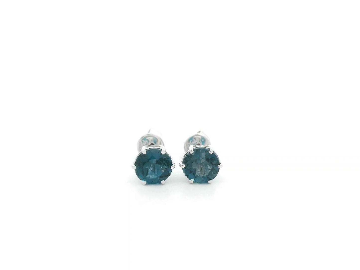 London Blue Topaz solitaire stud earrings in 18K white gold featuring 1.90 carats of natural round London Blue Topaz.