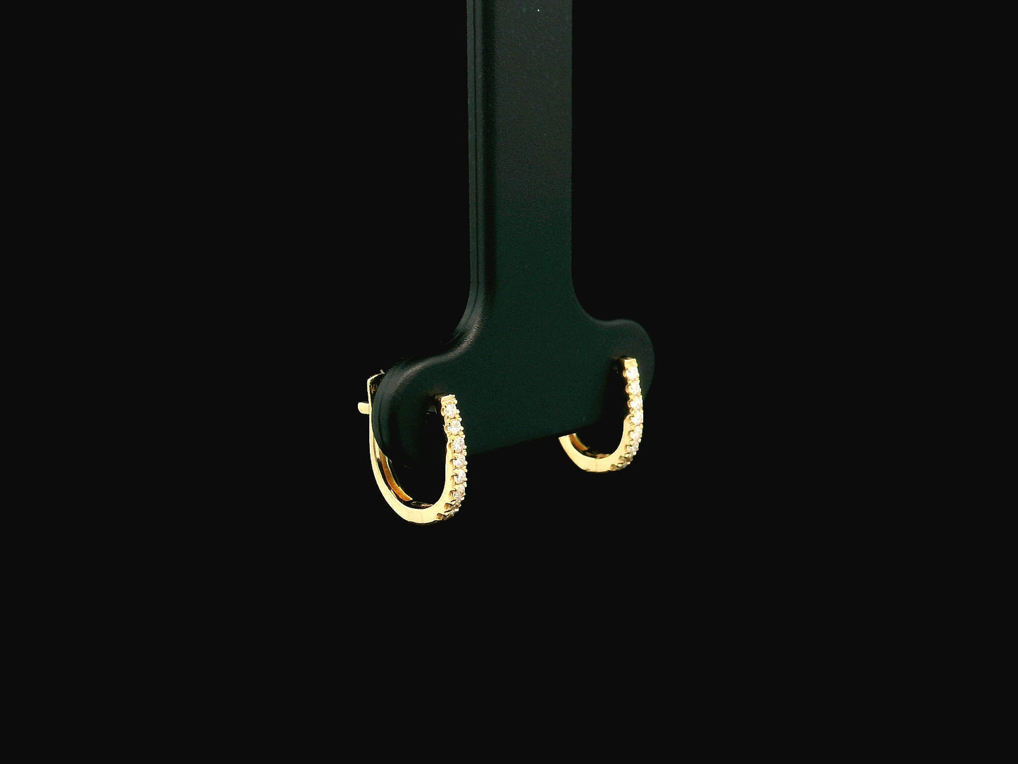 18K yellow gold diamond huggie hoop earrings featuring 0.09 carats of natural diamonds in a classic everyday hoop design.