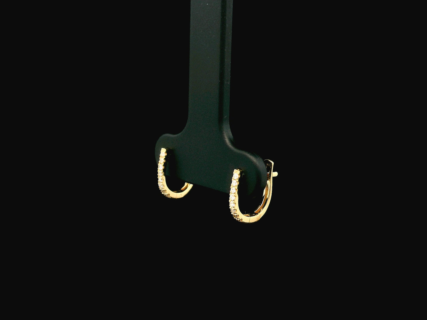 18K yellow gold diamond huggie hoop earrings featuring 0.09 carats of natural diamonds in a classic everyday hoop design.